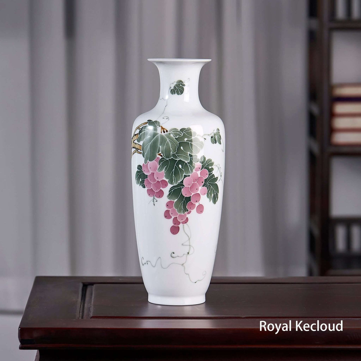 Chinese Porcelain Vase featuring elegant grape motif and ivory-like tones on a smooth surface.