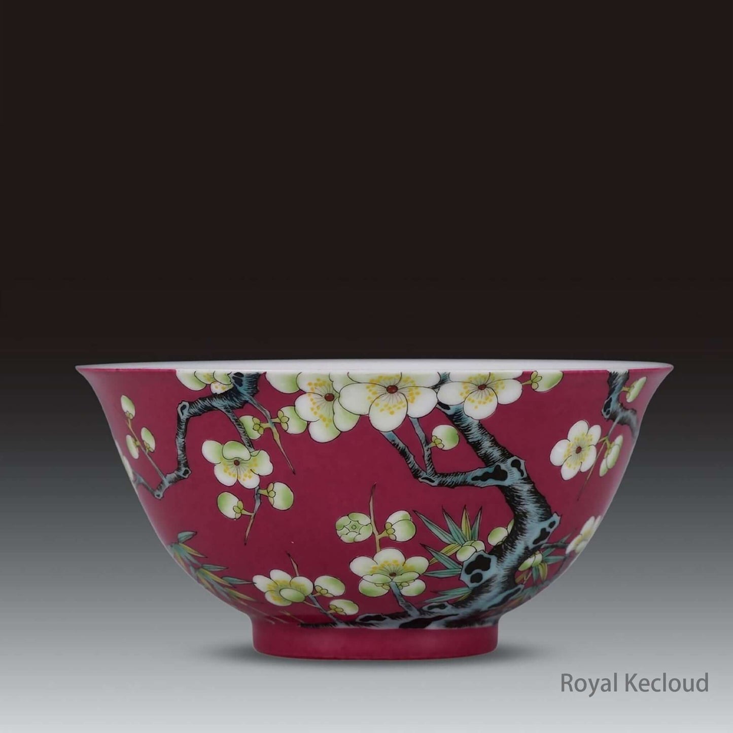Imperial Ceramic Bowl featuring ruby-red enamel and delicate prunus blossoms, showcasing Qing Dynasty craftsmanship.