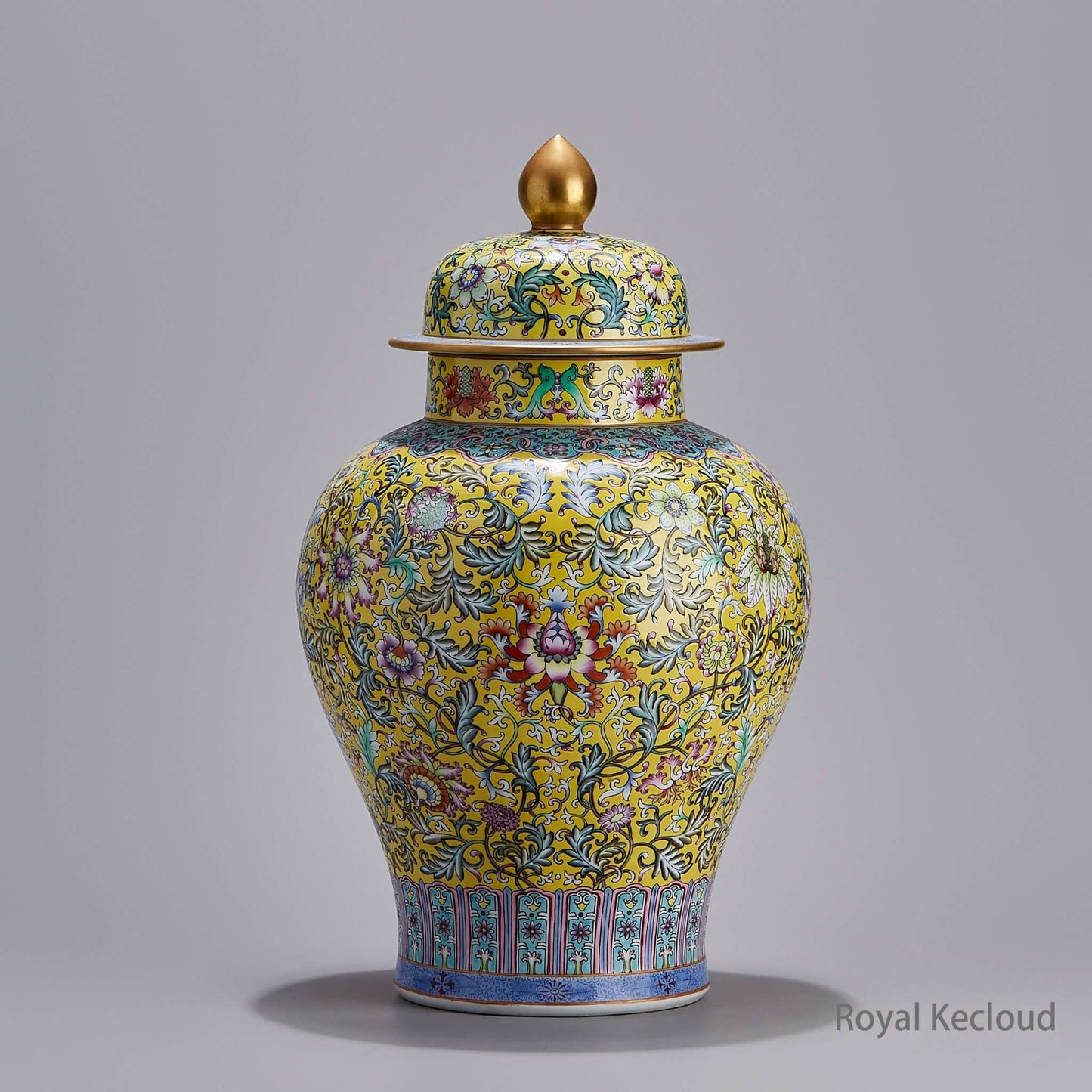 Famille Rose Porcelain Jar with intricate floral designs on yellow ground and a golden lid.